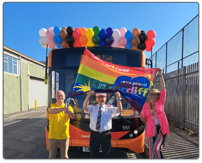 a photo of staff stood infront of Cardiff's Pride bus